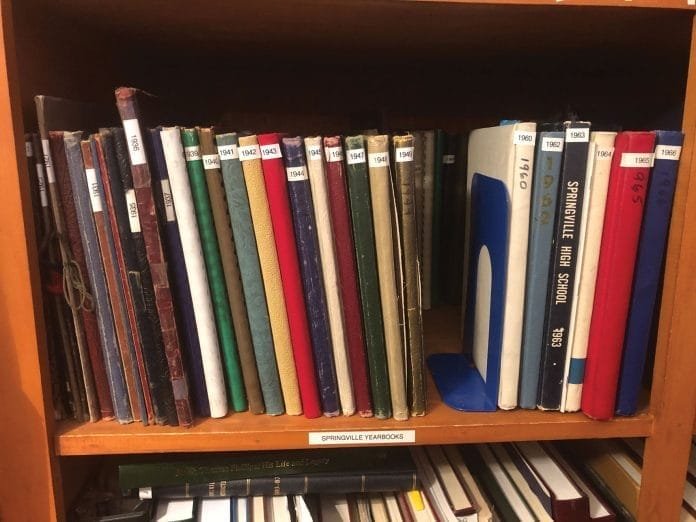 Note the yearbooks missing in the gap in this photo are currently out being digitized.