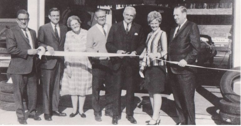 The 1969 Grand Opening of the current Johnson Tire Location. The four men in suits are believed to be representatives from Goodyear Tire. Woman on left is Esther Johnson, next to Ed Johnson, and the woman on the right is Beth Johnson.