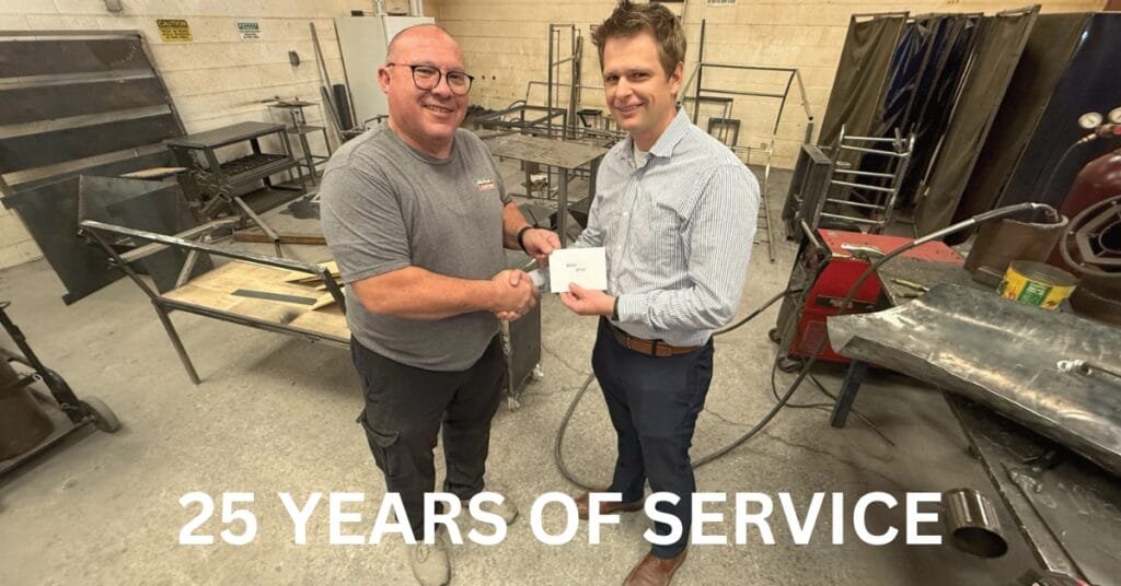 L-R: Springville High School Welding Teacher Brian Ostler and Bryce Packard with Springville Central Bank.