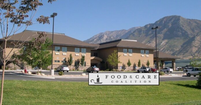 Volunteer serving a nutritious meal at the Food and Care Coalition in Provo, supporting local homelessness services.