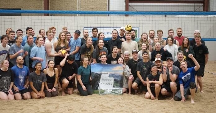 Players enjoying indoor sand volleyball at Beach House in Springville, Utah, during the winter season.
