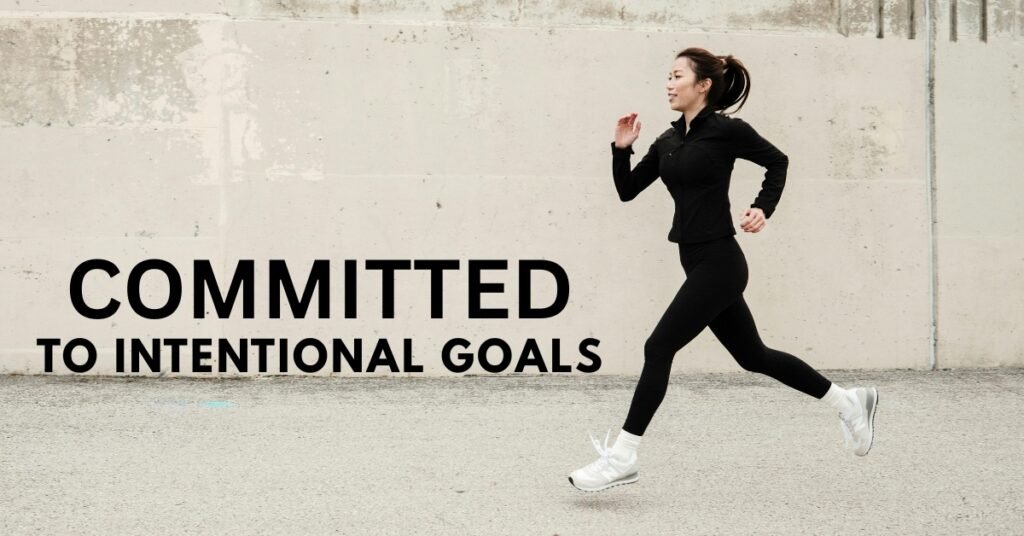 A determined person running down a long street, symbolizing the unwavering commitment needed to achieve personal development goals.
