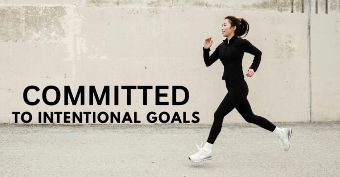 A determined person running down a long street, symbolizing the unwavering commitment needed to achieve personal development goals.