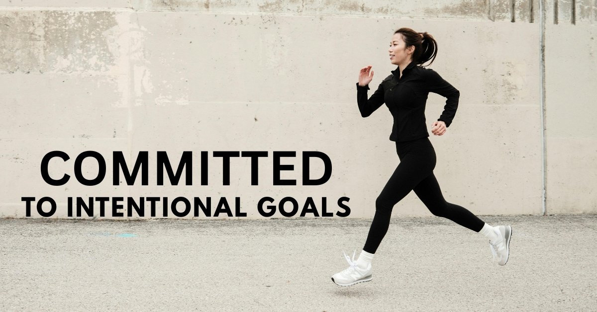 A determined person running down a long street, symbolizing the unwavering commitment needed to achieve personal development goals.