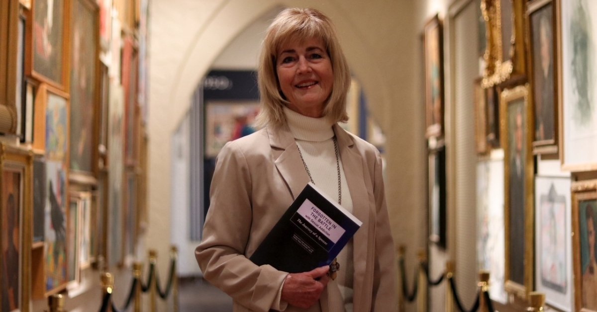 Author Roxanna Johnson’s holding her book, symbolizing betrayal trauma recovery and self-preparedness for spouses.