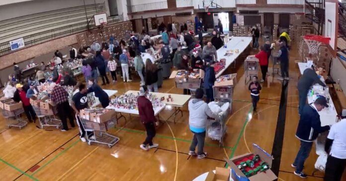 Volunteers packing boxes for the Springville Kiwanis Food Drive, showing community support and charitable giving.
