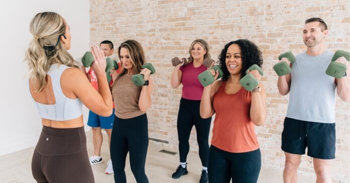 Kara Simmons leading an Upbeat Lift choreographed strength training class with dumbbells at a Clyde Recreation Center.
