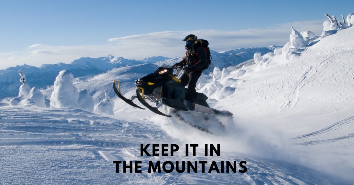A snowmobile carving through deep mountain powder, illustrating the "White-ish Christmas" dream of keeping snow off the roads.