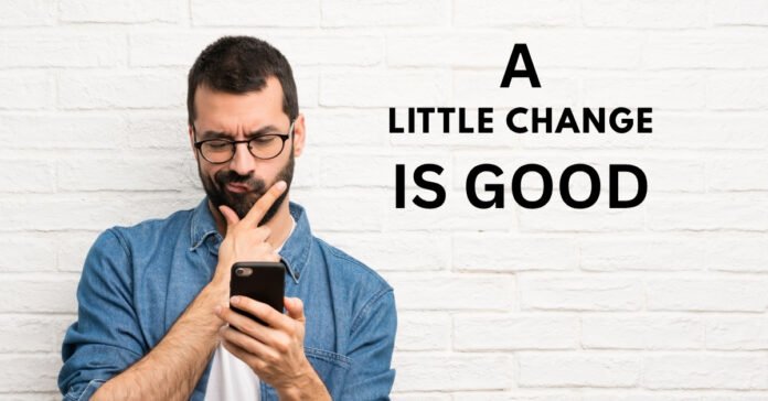 A man looking at a phone, illustrating how embracing life's little changes can lead to positive personal growth.